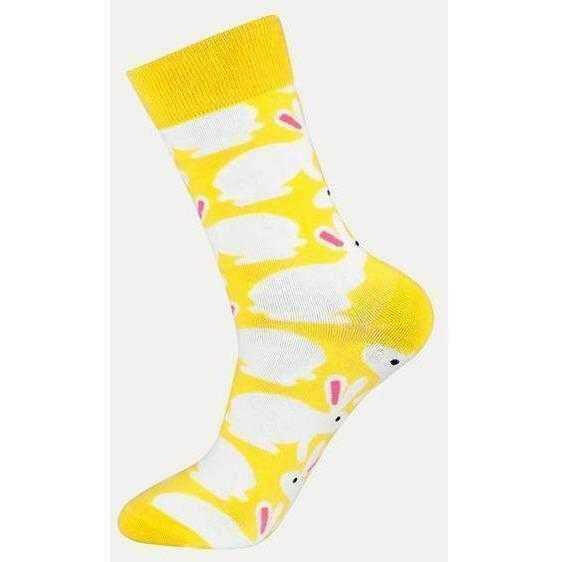 a yellow fire hydrant sitting on top of a table