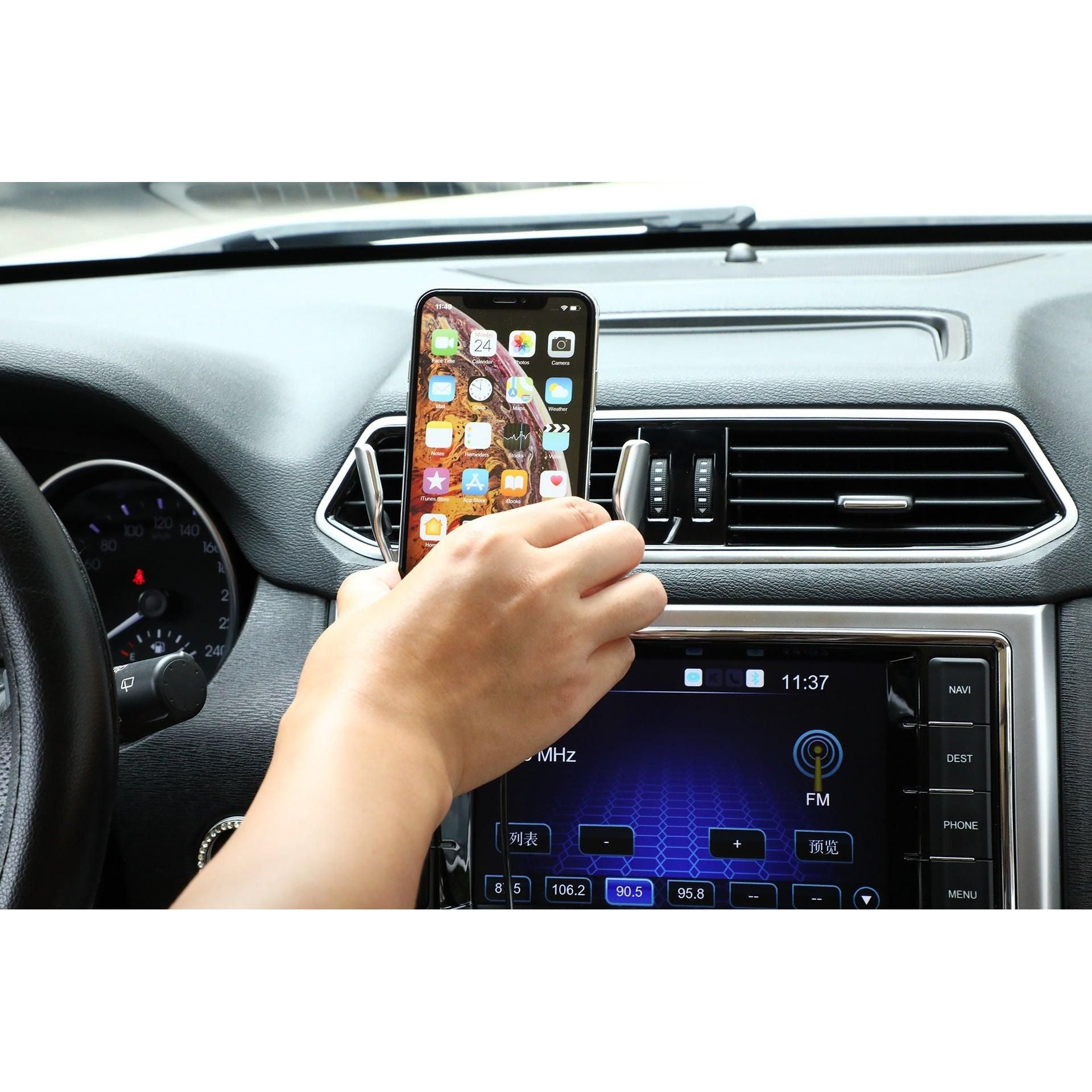 a person holding a remote control in a car