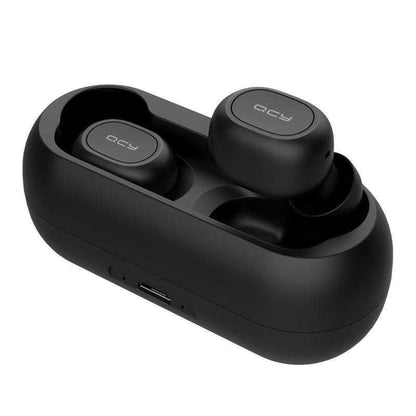 a pair of shoes sitting on top of a suitcase 
