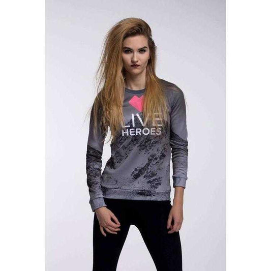 a woman standing next to a wall with a purse