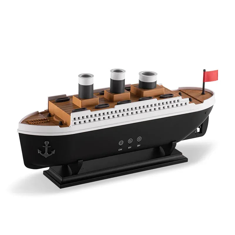 Titanic-style ship-shaped AromaMist diffuser with three funnels and a red flag, on its black display stand, white background