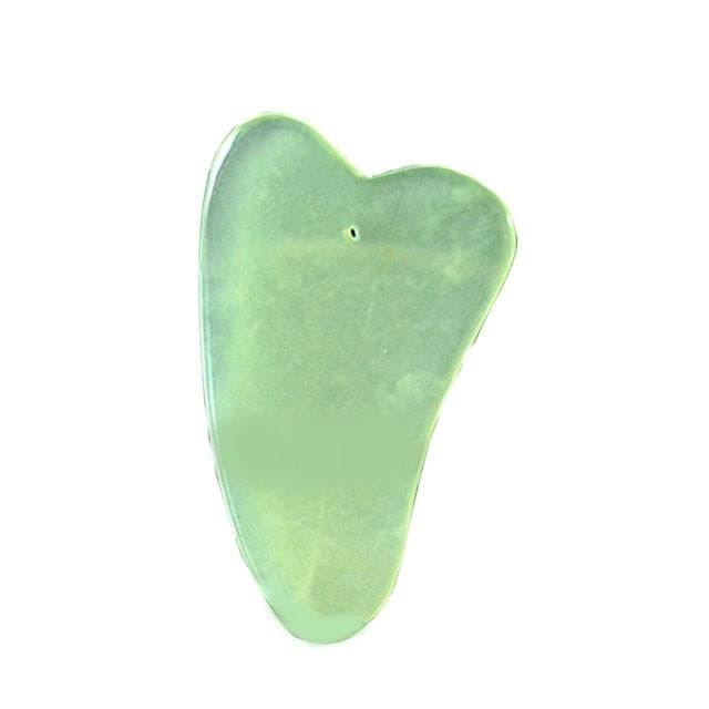 a green apple is sitting on a green surface 