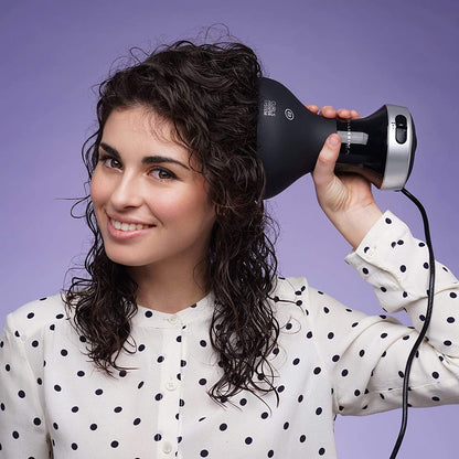 a woman holding a hair dryer in her hand 