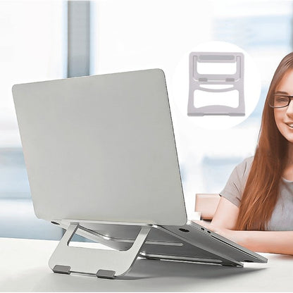 a woman sitting in front of a laptop computer 