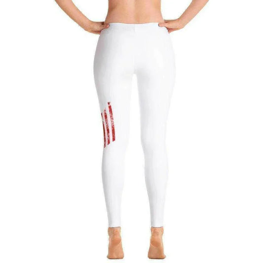 a woman in a white dress on top of a bench