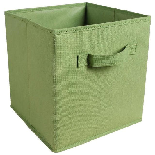 a green suitcase sitting on top of a green box