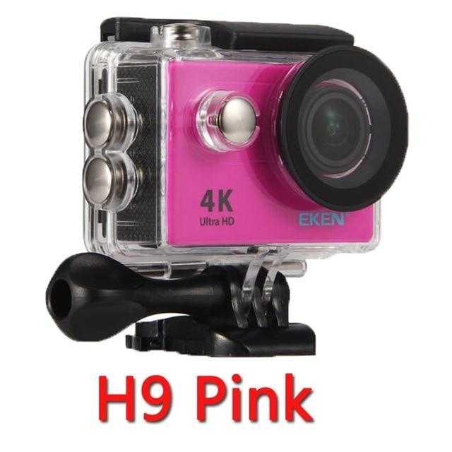 a close up of a pink camera on a table 
