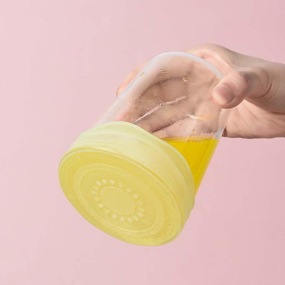 a person holding a yellow frisbee in their hand 