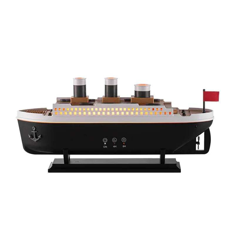 AromaMist ship diffuser in side view with its row of porthole lights glowing orange, white background